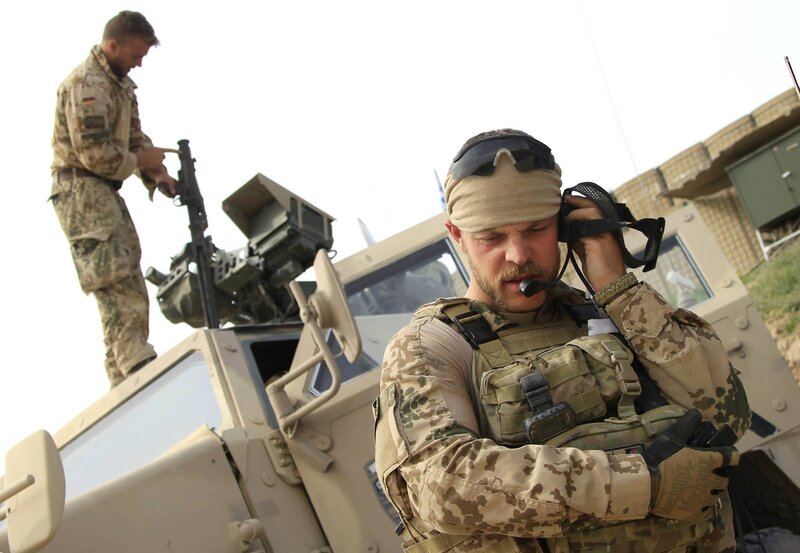 Soldiers on military vehicle