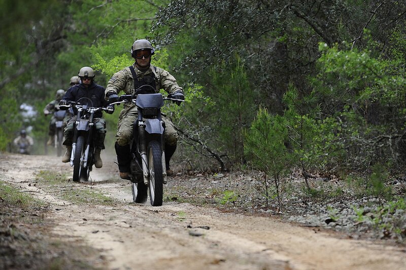 Soldiers on motorcycles in forest