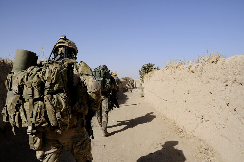 Soldiers on patrol in a narrow alley