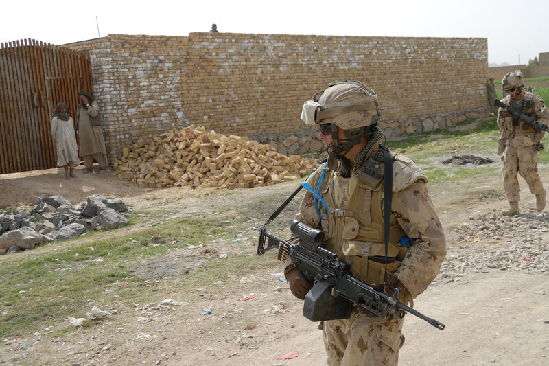Soldiers on patrol in a village