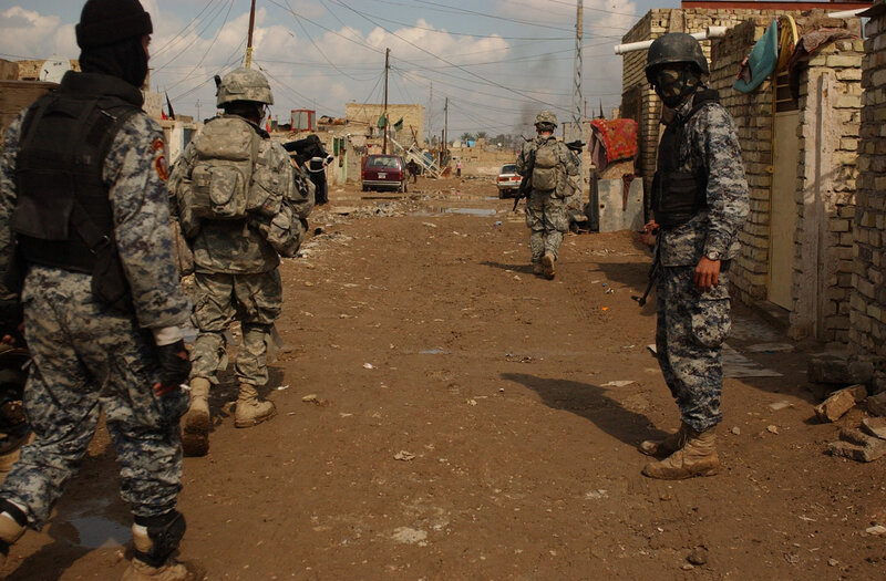 Soldiers on patrol in a war-torn street