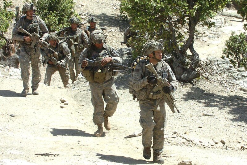 Soldiers on patrol in desert terrain
