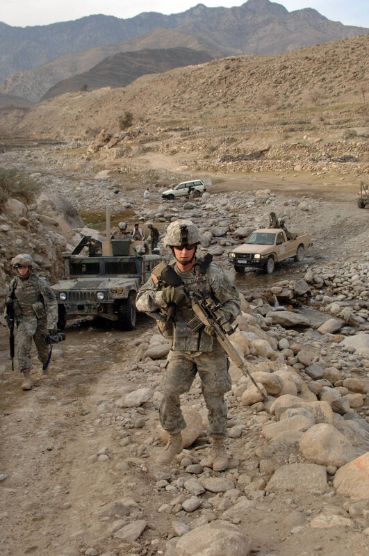 Soldiers on patrol in mountainous terrain