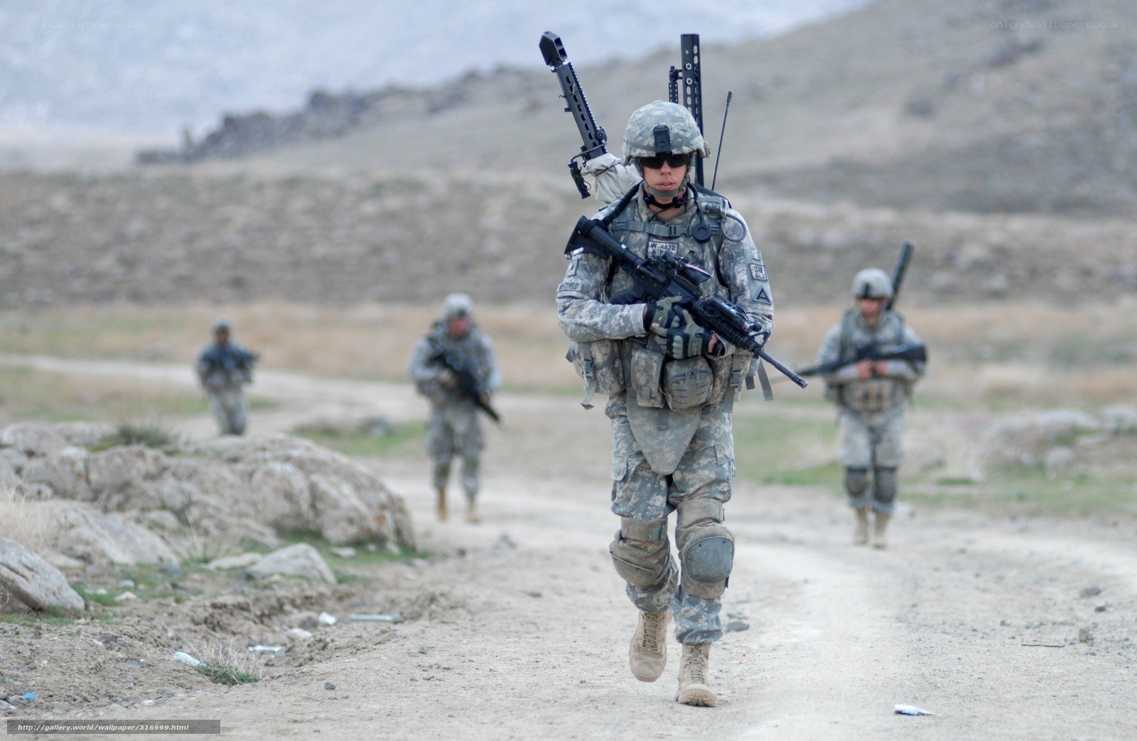 Soldiers on patrol in mountainous terrain