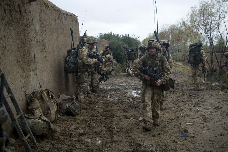 Soldiers on patrol in muddy terrain