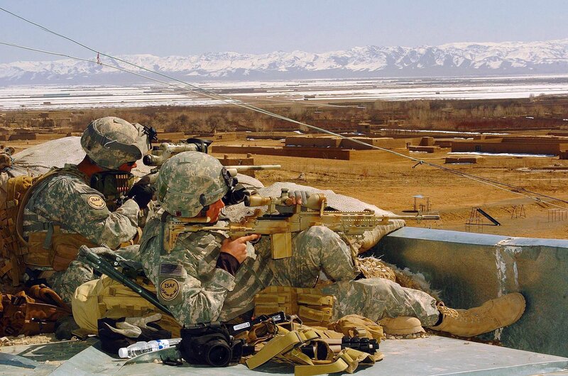 Soldiers on rooftop with rifles