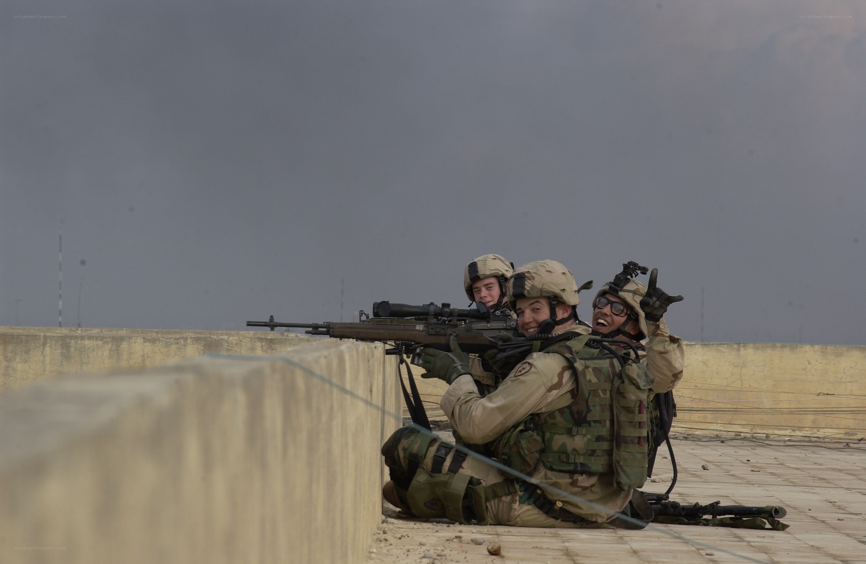 Soldiers on rooftop with weapons