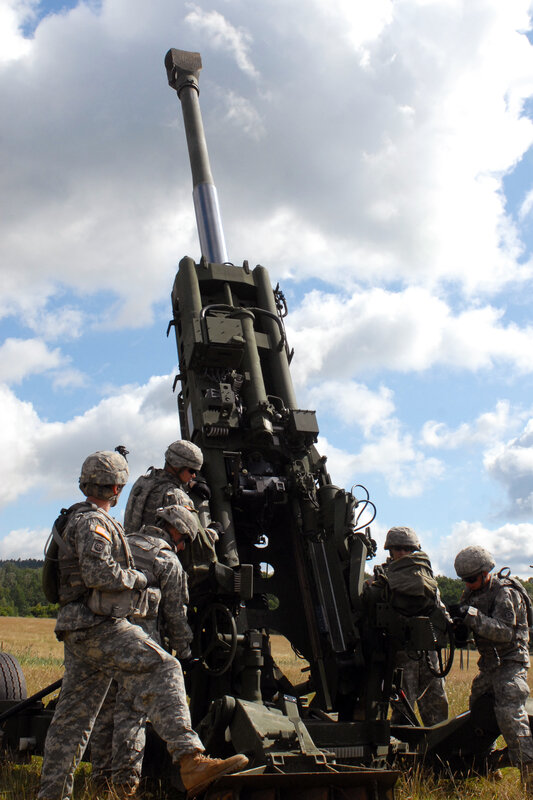 Soldiers operating artillery cannon