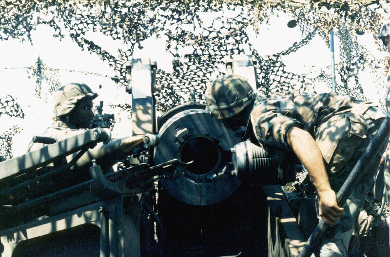 Soldiers operating artillery gun