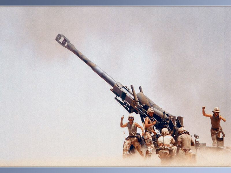 Soldiers operating artillery in desert