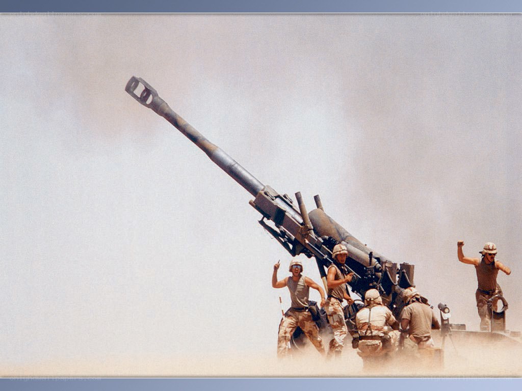 Soldiers operating artillery in desert