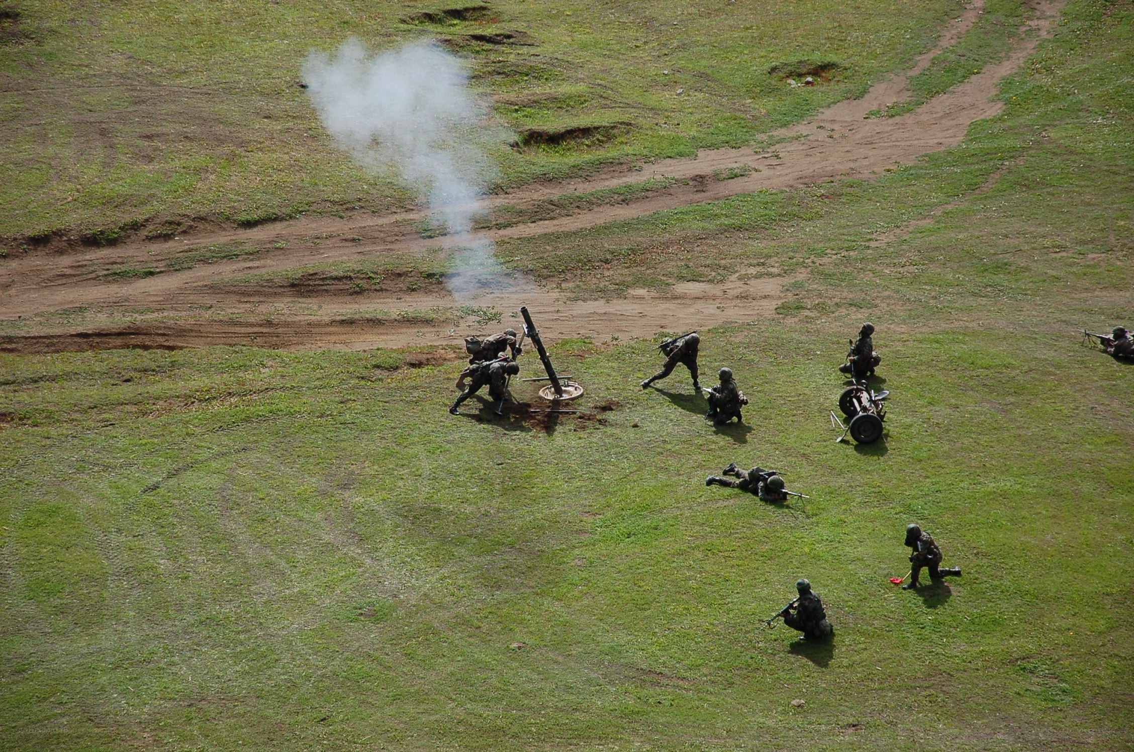 Soldiers operating artillery in field