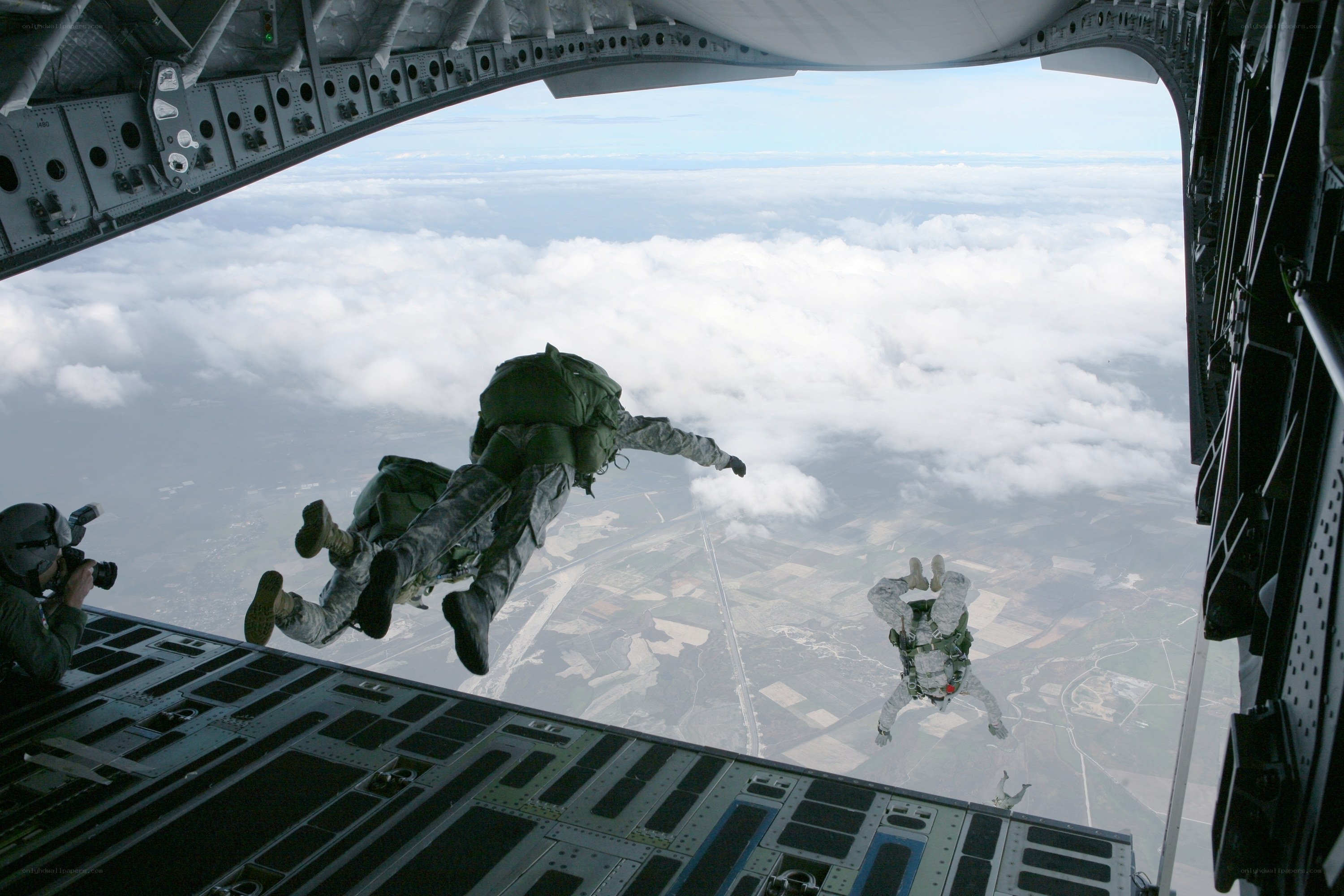 Soldiers parachuting from aircraft