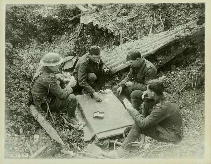Soldiers playing cards in a trench