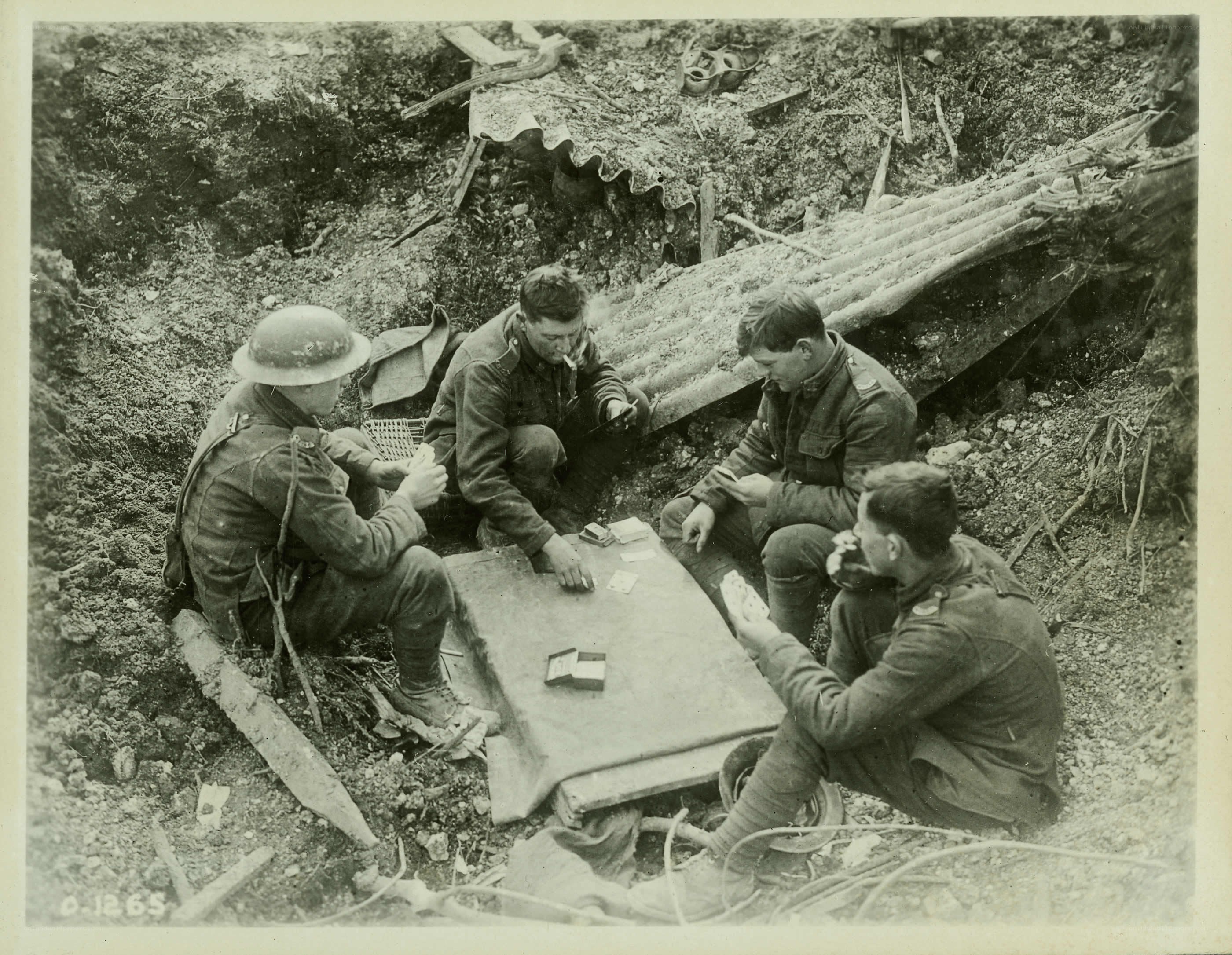 Soldiers playing cards in a trench