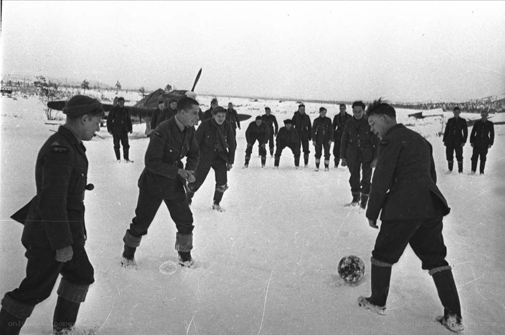 Soldiers playing soccer in snow