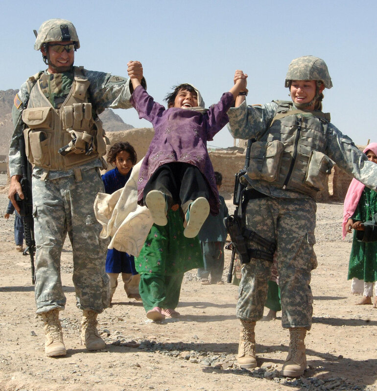 Soldiers playing with a child