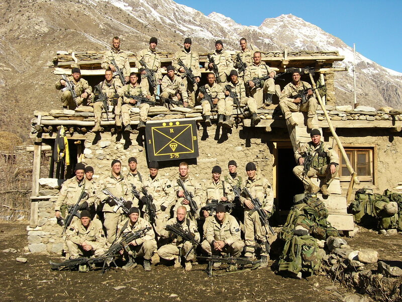 Soldiers pose with flag