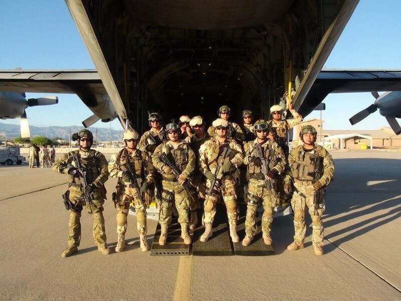 Soldiers posing by military aircraft