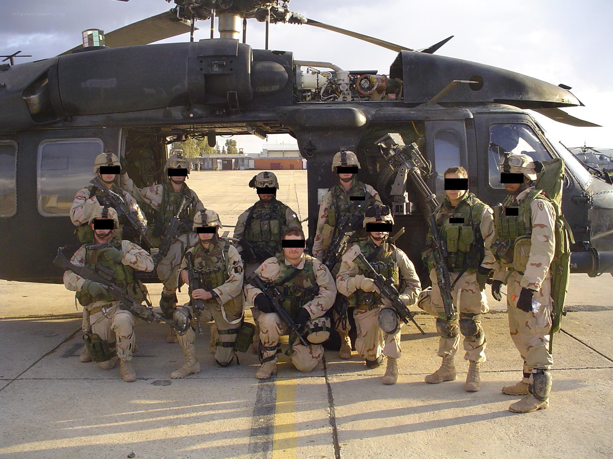 Soldiers posing with helicopter