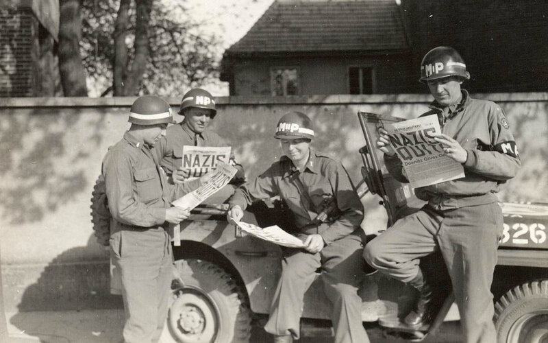 Soldiers reading newspaper