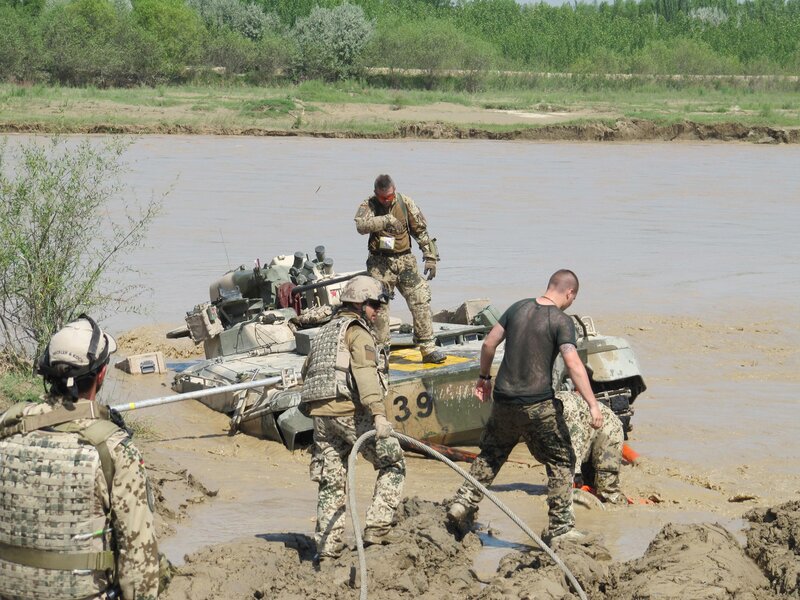 Soldiers recovering a tank from river