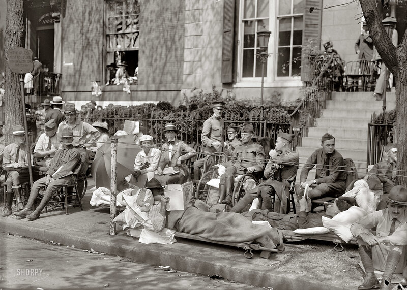 Soldiers resting on a city sidewalk