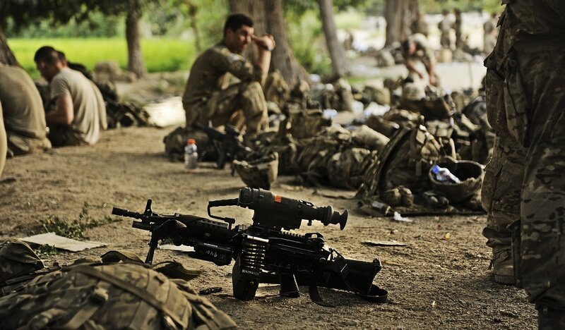 Soldiers resting with weapons