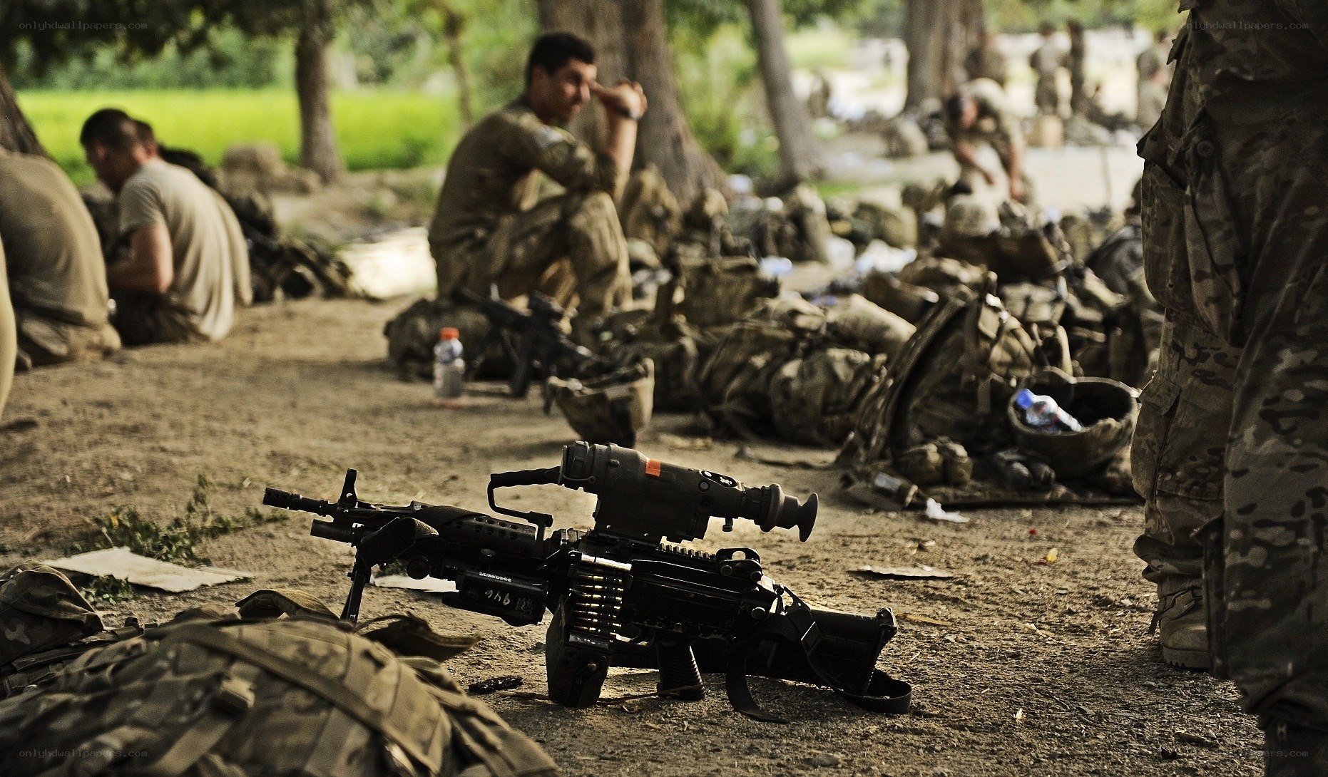 Soldiers resting with weapons