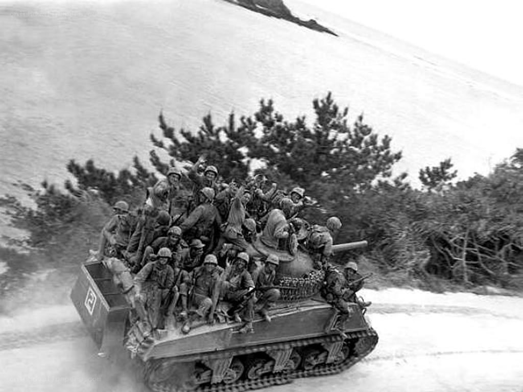 Soldiers riding a tank