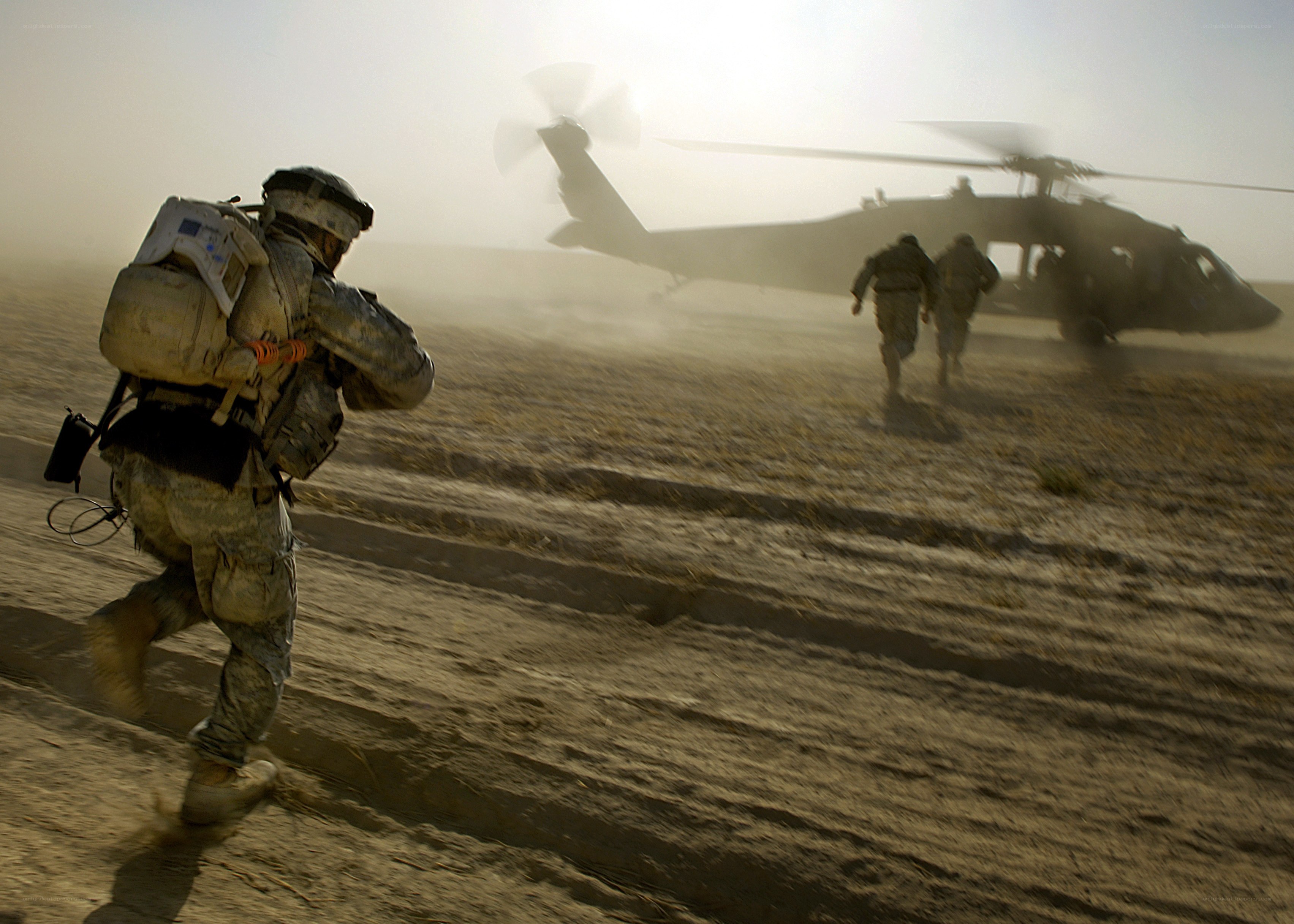 Soldiers running to helicopter