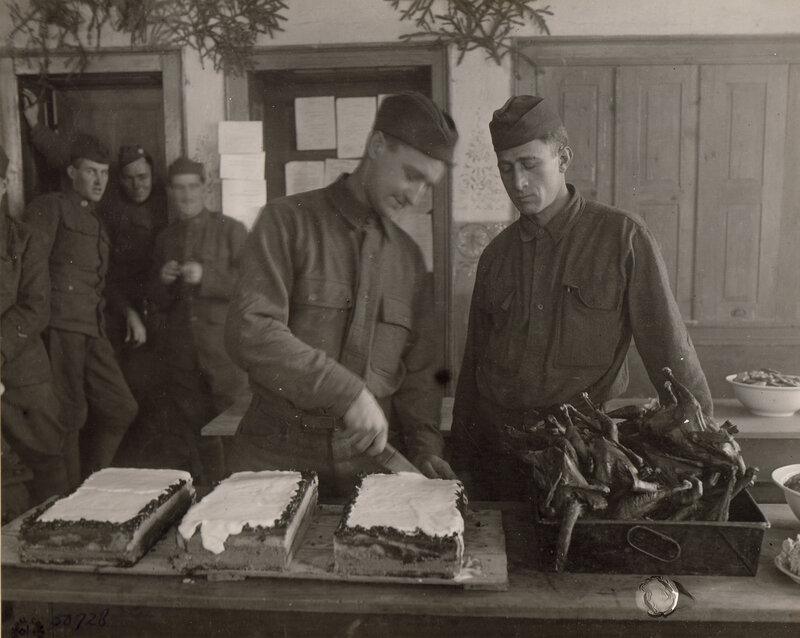 Soldiers serving food in a mess hall