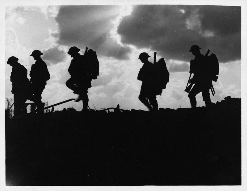 Soldiers silhouetted against sky