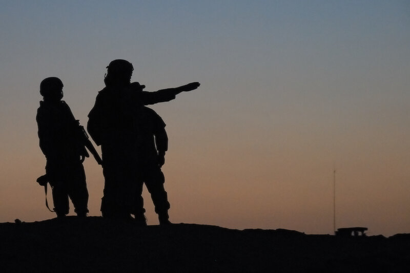 Soldiers silhouetted at dusk