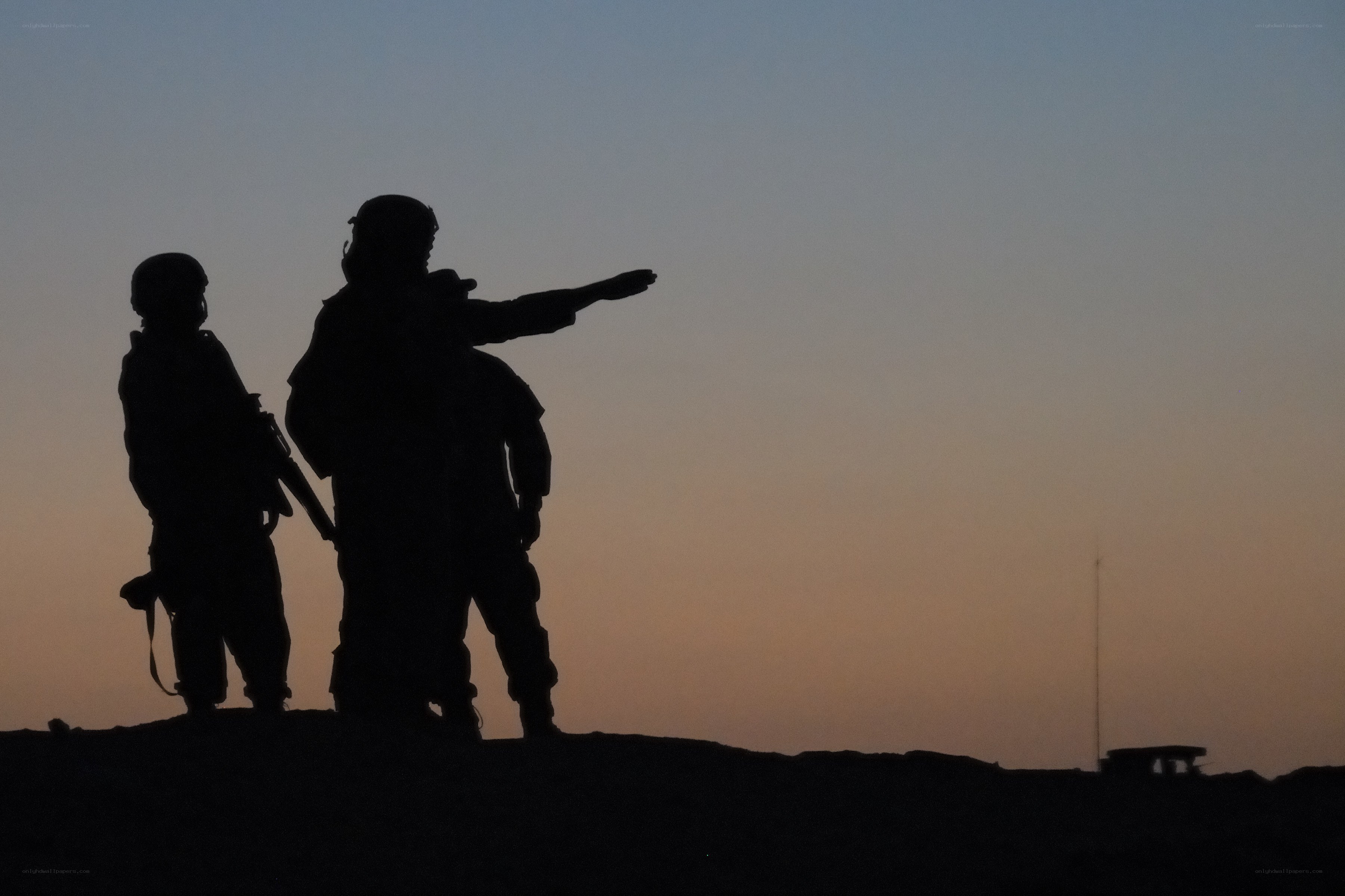 Soldiers silhouetted at dusk
