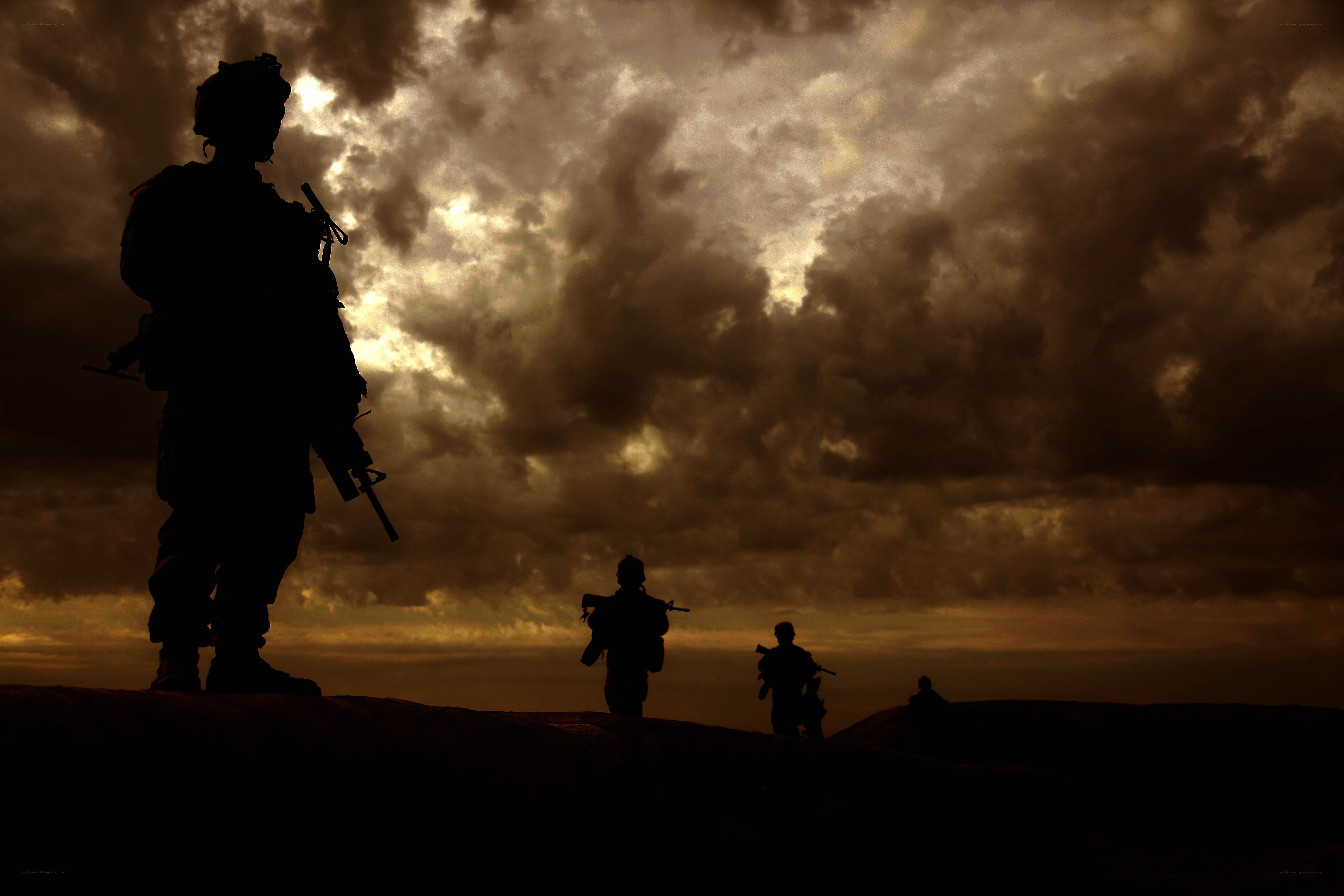 Soldiers silhouetted at dusk