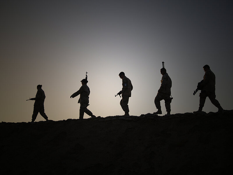 Soldiers silhouetted at dusk