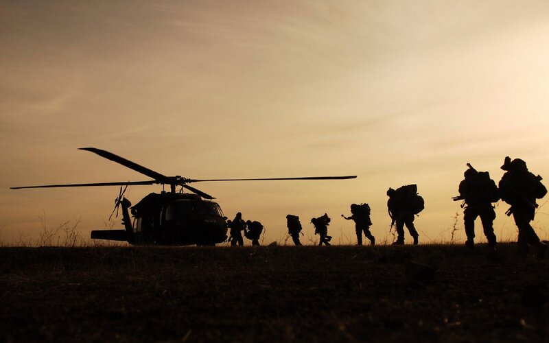 Soldiers silhouetted at dusk