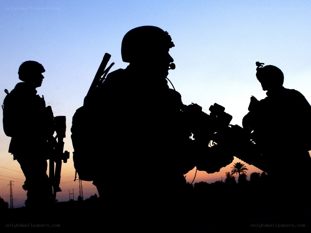 Soldiers silhouetted at dusk