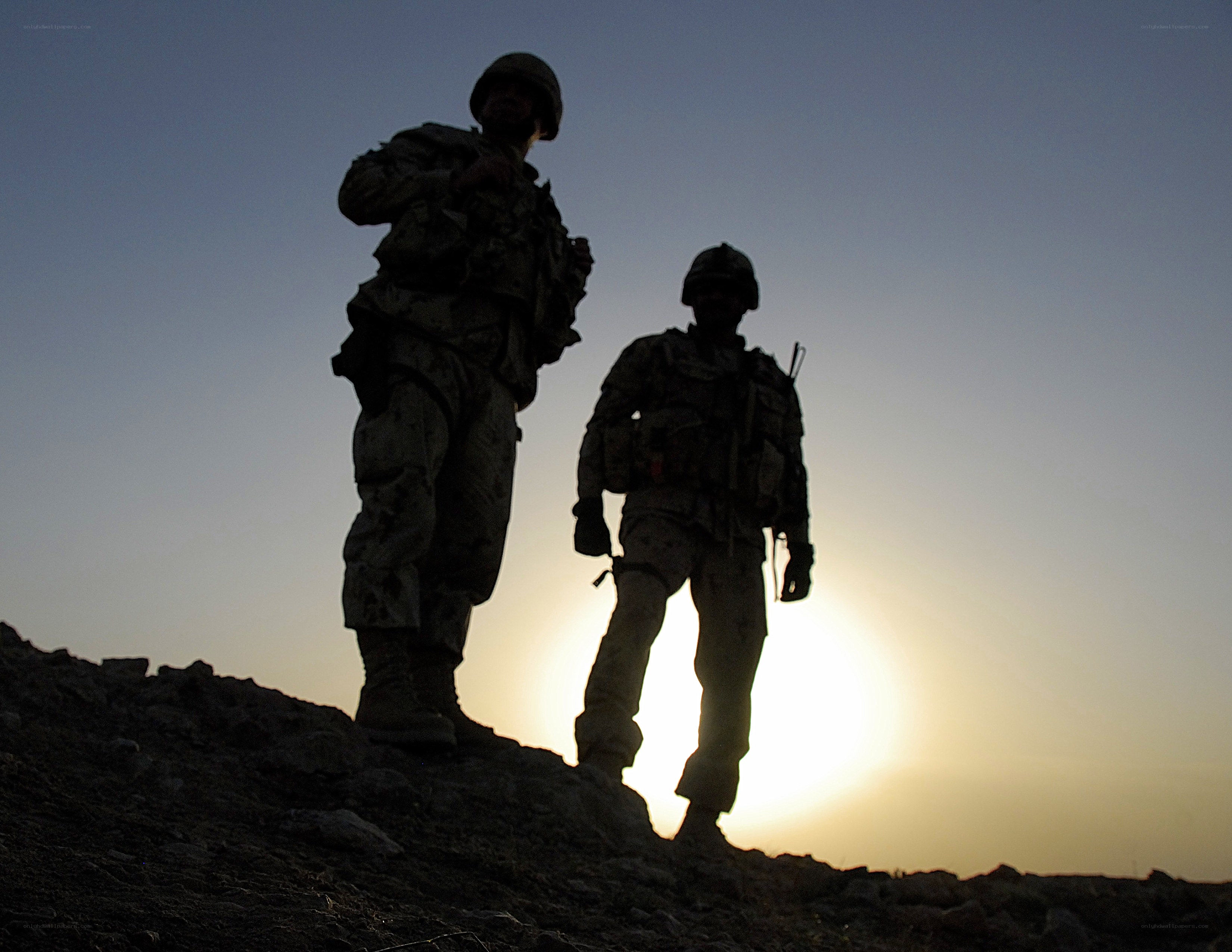 Soldiers silhouetted at sunset
