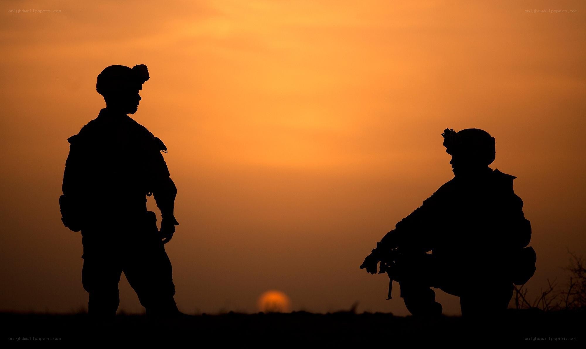 Soldiers silhouetted at sunset