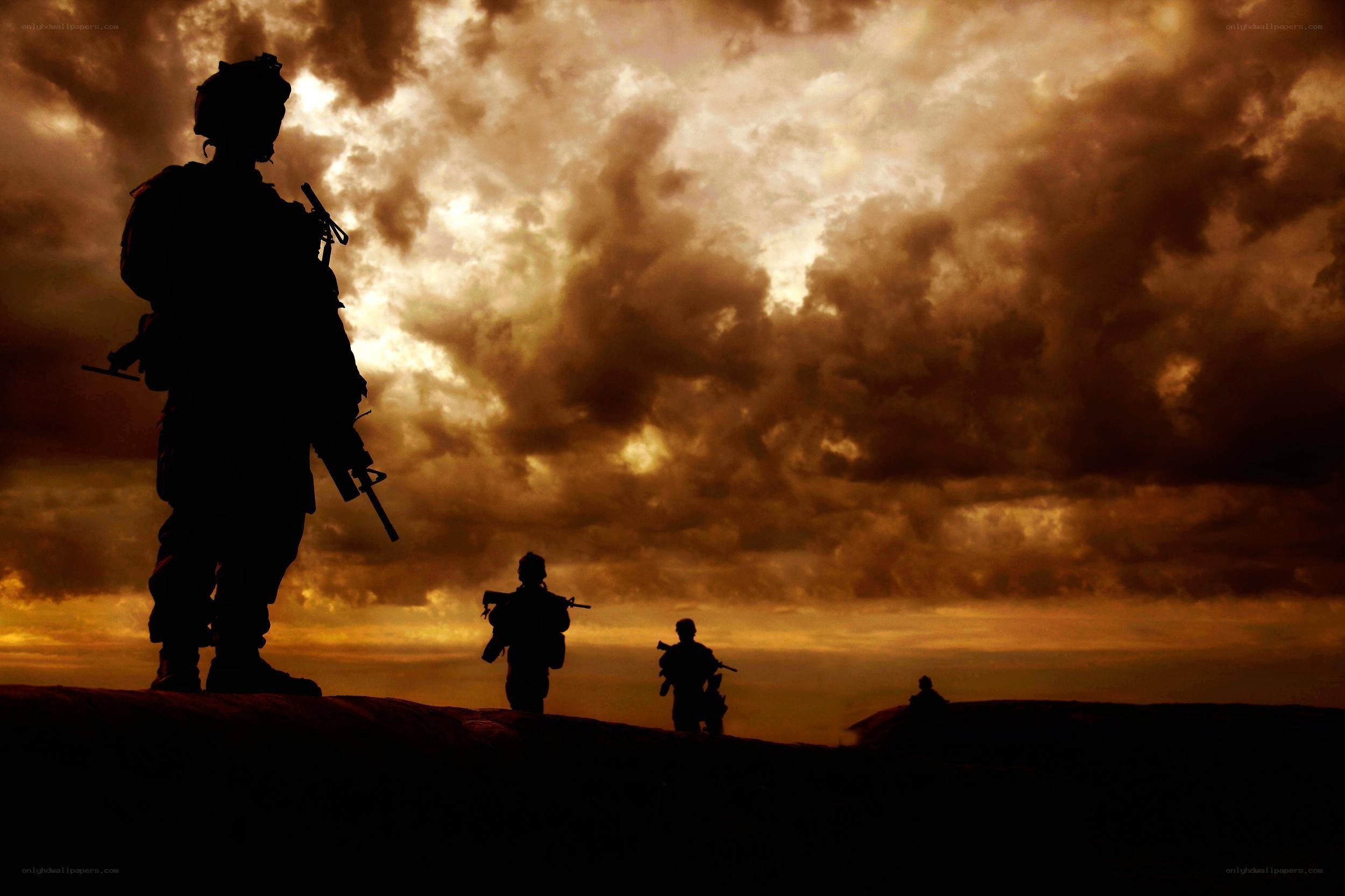 Soldiers silhouetted at sunset
