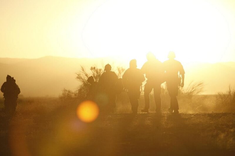 Soldiers silhouetted at sunset