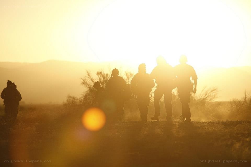 Soldiers silhouetted at sunset