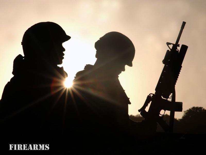Soldiers silhouetted at sunset