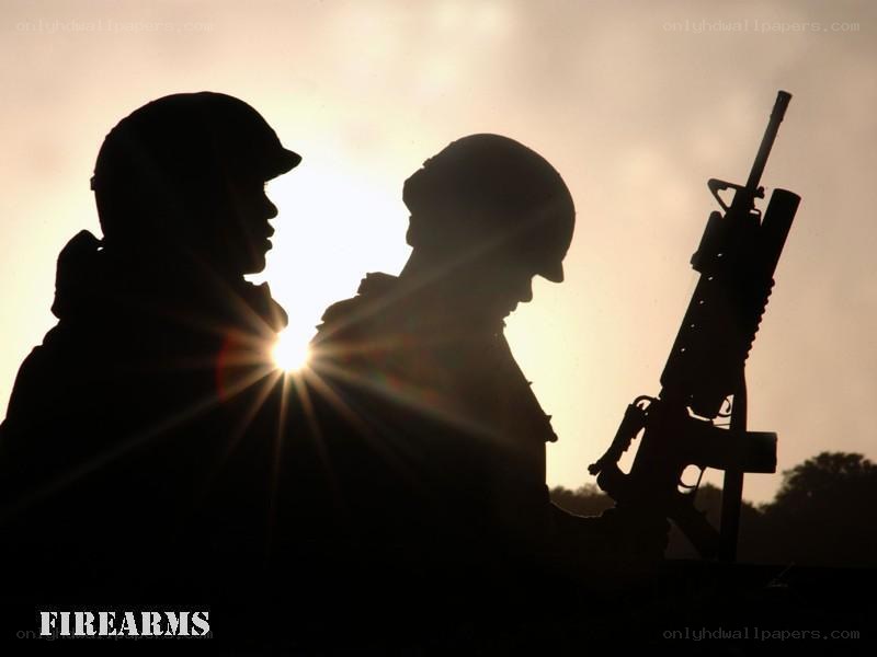 Soldiers silhouetted at sunset