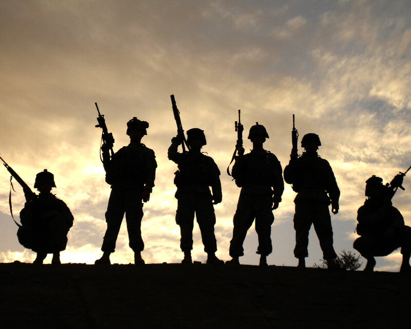 Soldiers silhouetted at sunset