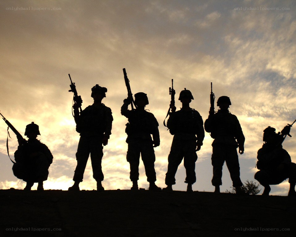Soldiers silhouetted at sunset