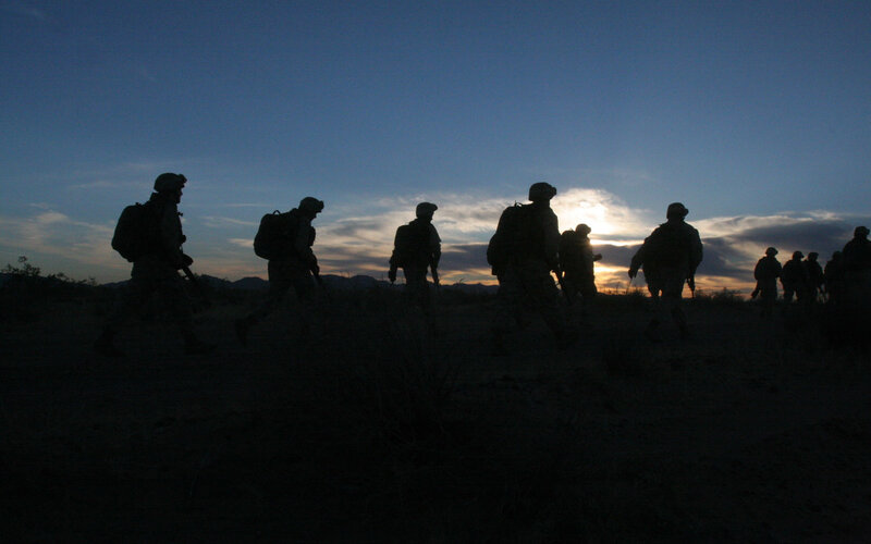Soldiers silhouetted at sunset