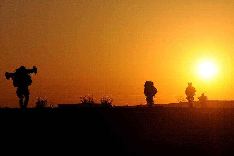 Soldiers silhouetted at sunset